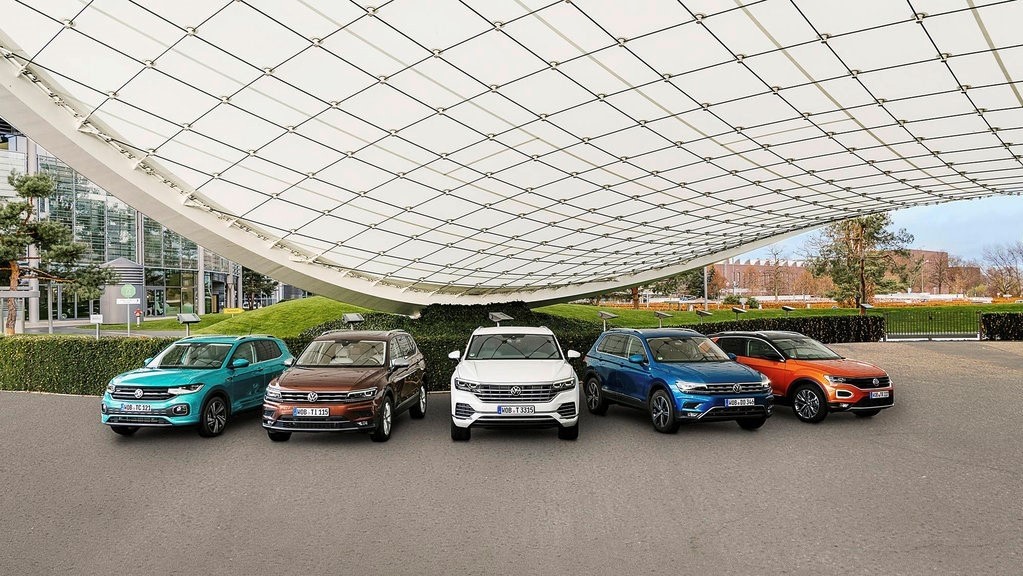 four cars in front of a rocky coast