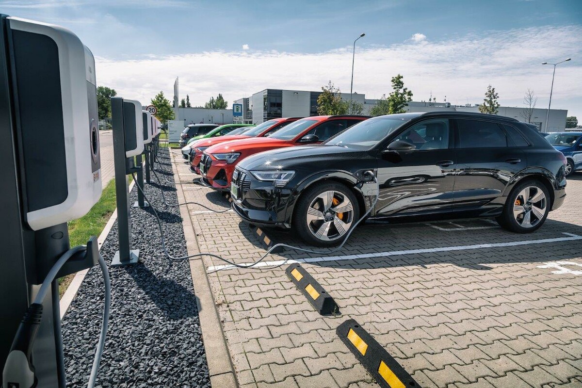 four cars in front of a rocky coast