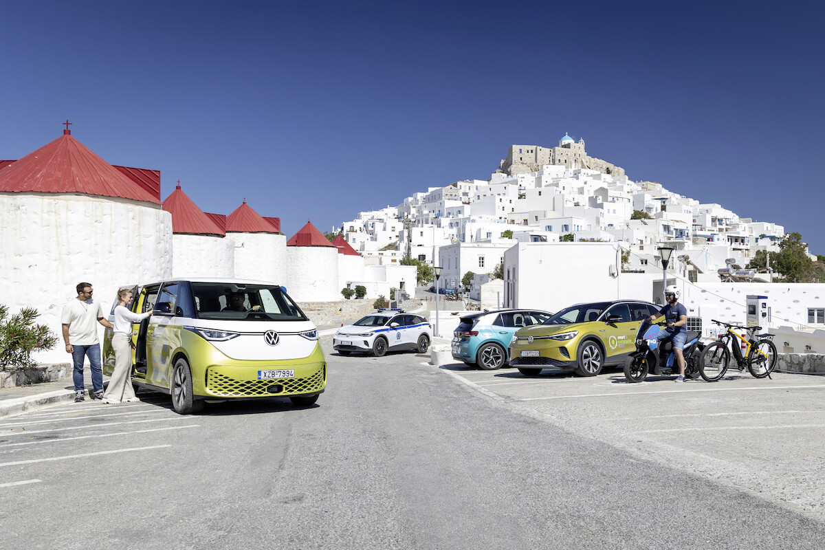 four cars in front of a rocky coast